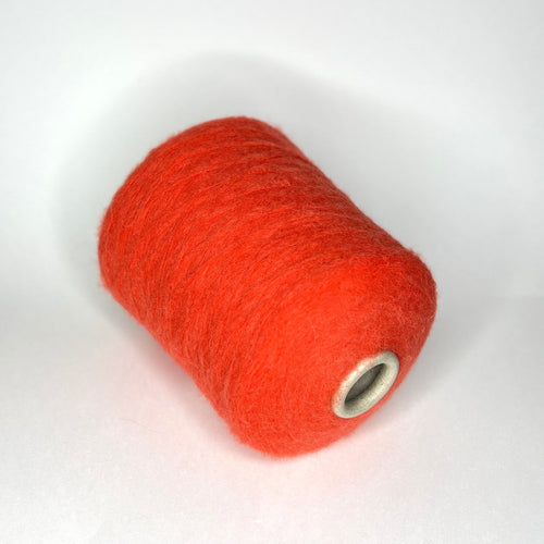 Luxurious orange yarn, soft with a subtle 'porridge' heathered texture. Features a delicate alpaca halo, gentle sheen, and a fine, even single-ply twist.