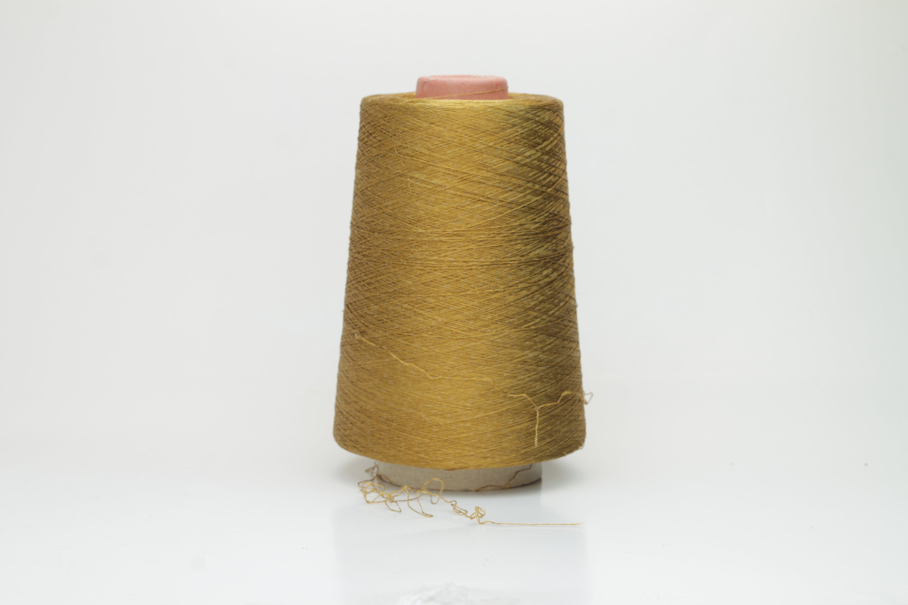 Luxurious deep bronze yarn with a distinct spiral twist, showcasing a radiant metallic sheen and smooth, tightly spun fibers.