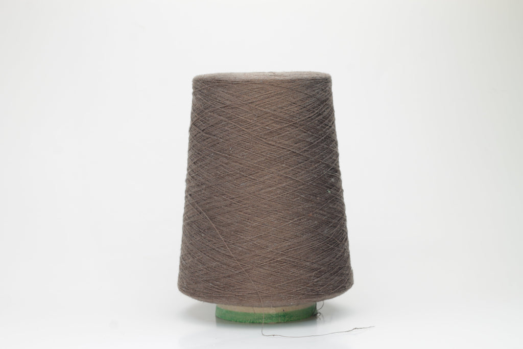 Coiled skein of deep marrone brown yarn, showcasing silk's subtle sheen and linen's crisp texture. A tight two-ply twist creates a smooth, even thread structure.