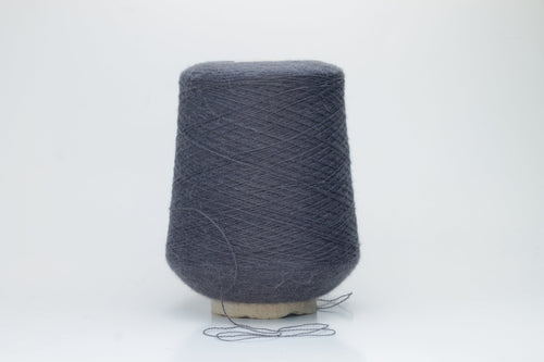 Soft, heathered gray luxury yarn, gently twisted, with a delicate alpaca halo and a subtle matte sheen, ready for knitting.