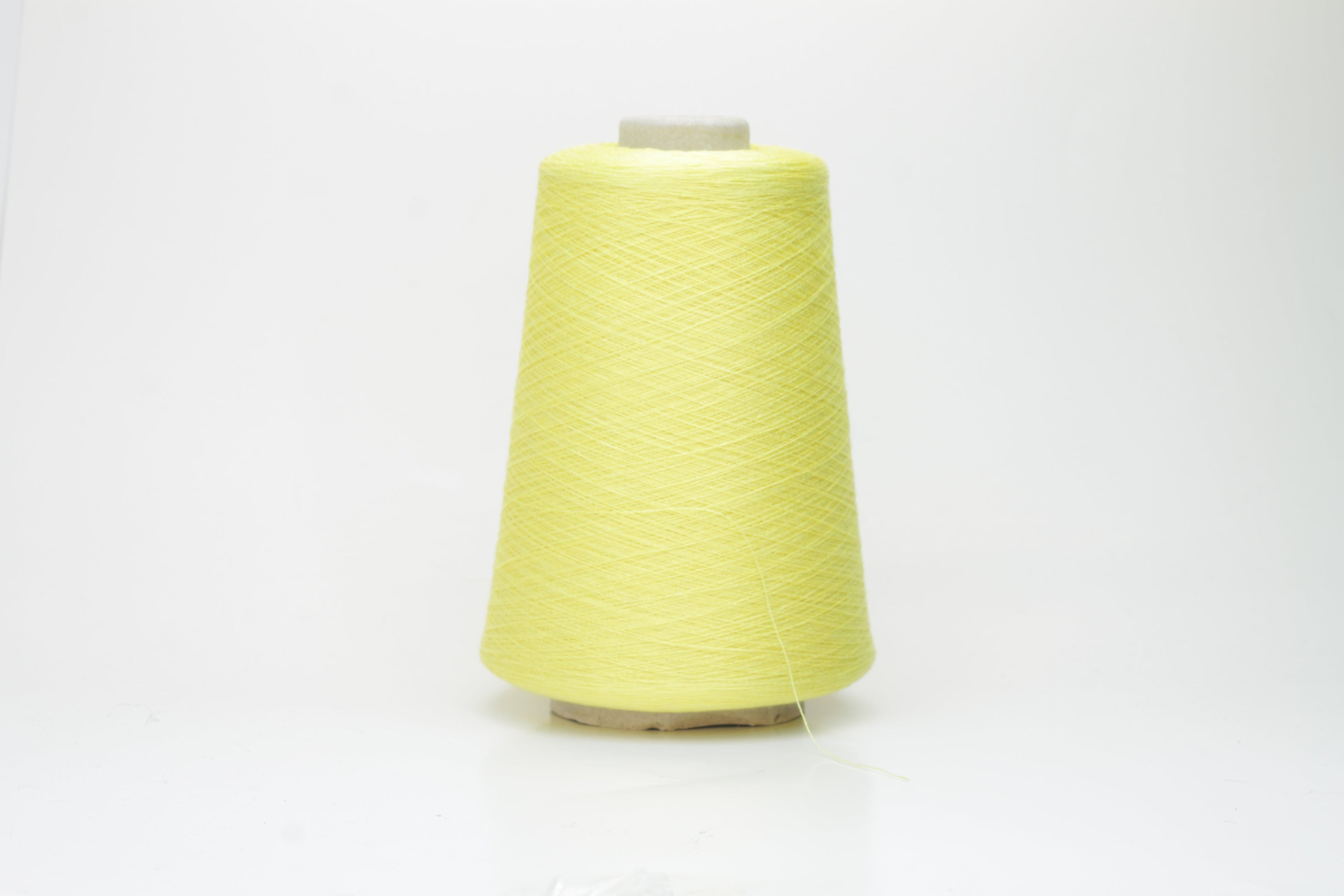 A finely spun, single-ply yarn in a vibrant, sunny golden-yellow. Smooth silk-cotton blend with a subtle, luxurious sheen and delicate twist.