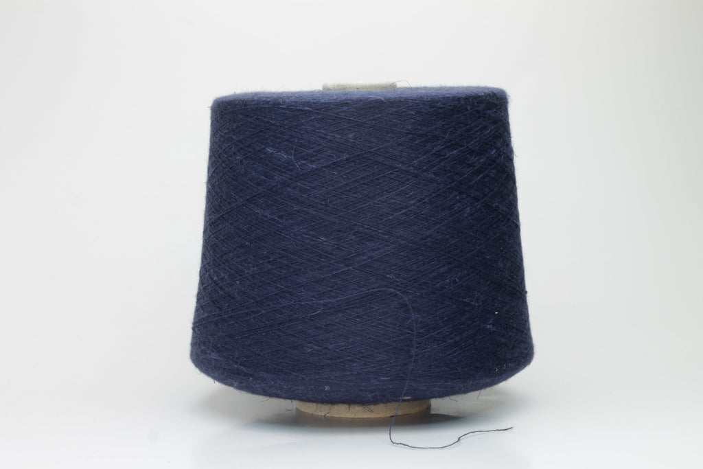 A finely plied, three-strand yarn in a deep, rich dark blue. The smooth threads exhibit a subtle, lustrous sheen under light.