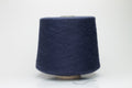 A finely plied, three-strand yarn in a deep, rich dark blue. The smooth threads exhibit a subtle, lustrous sheen under light.