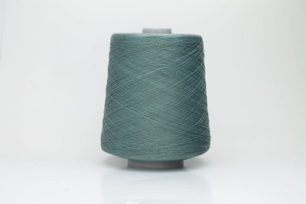 A finely spun skein of vibrant green silk cotton yarn with a subtle, natural sheen. The tight, smooth twist of the fibers is visible.