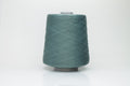 A finely spun skein of vibrant green silk cotton yarn with a subtle, natural sheen. The tight, smooth twist of the fibers is visible.