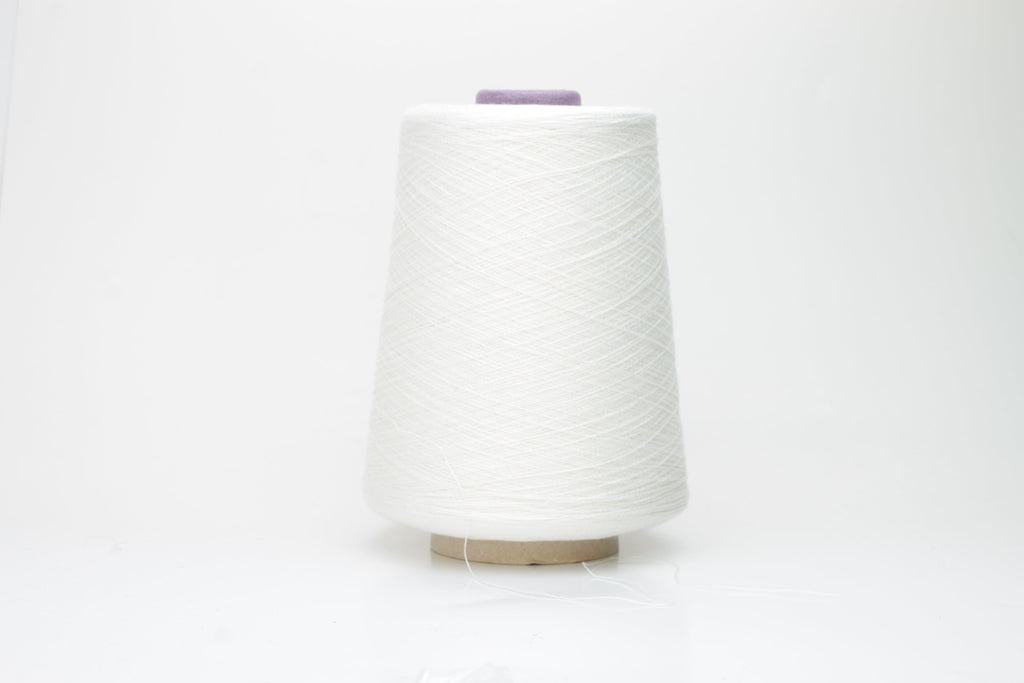 A meticulously spun, single-ply white yarn with a subtle sheen, gracefully coiled into a pristine hank, revealing its fine, smooth texture.