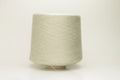 Close-up of a delicate, smoothly twisted light gray yarn strand, showing fine ply definition, subtle sheen, and gentle fluff.