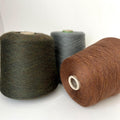 Soft, slightly twisted strand of luxury cashmere-alpaca yarn in a rich, nuanced moleskin grey-brown with a delicate halo and subtle sheen.