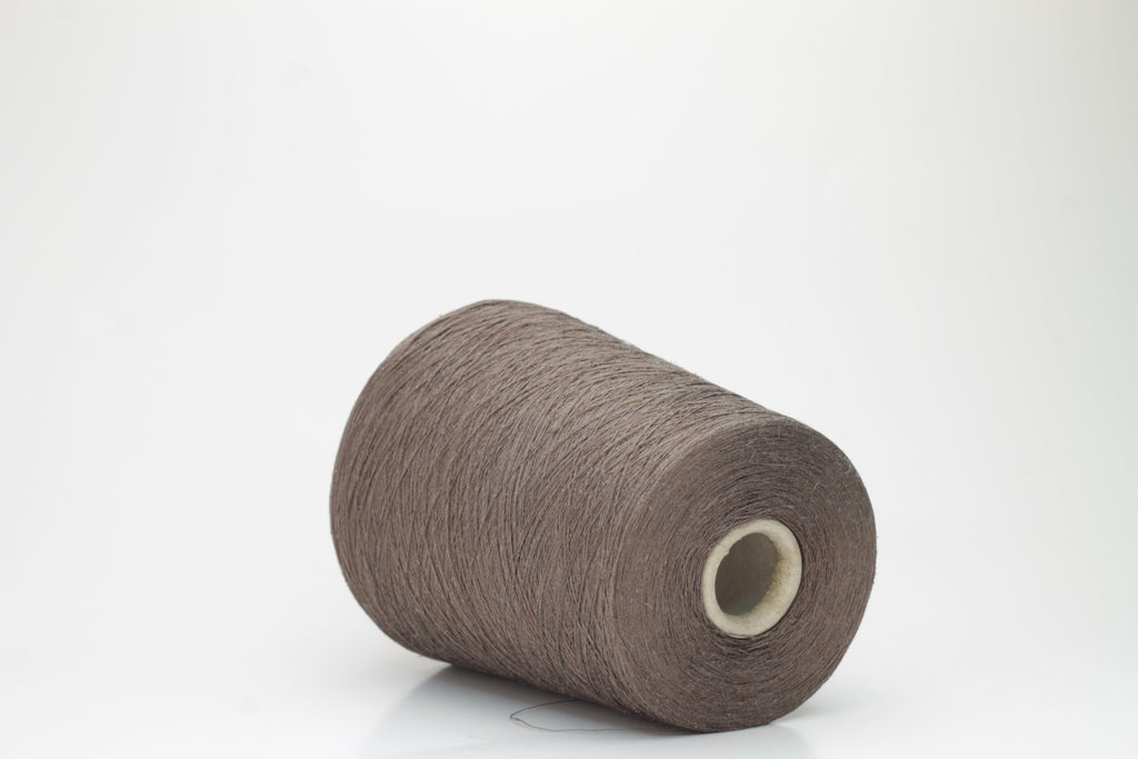 Coiled skein of deep marrone brown yarn, showcasing silk's subtle sheen and linen's crisp texture. A tight two-ply twist creates a smooth, even thread structure.