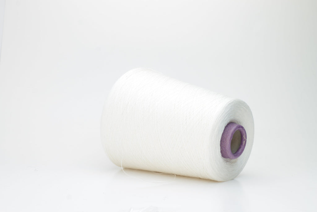 A meticulously spun, single-ply white yarn with a subtle sheen, gracefully coiled into a pristine hank, revealing its fine, smooth texture.