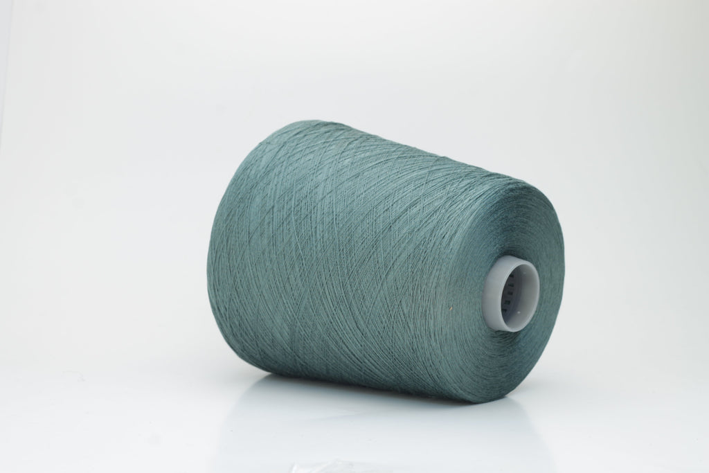A finely spun skein of vibrant green silk cotton yarn with a subtle, natural sheen. The tight, smooth twist of the fibers is visible.