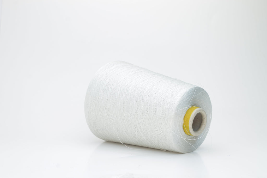 Coiled skein of finely spun, two-ply light gray yarn with a subtle, cool metallic sheen, demonstrating a smooth, uniform twist and refined texture.