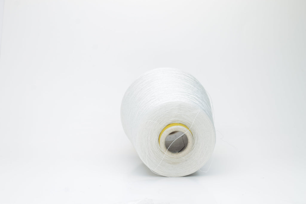 Coiled skein of finely spun, two-ply light gray yarn with a subtle, cool metallic sheen, demonstrating a smooth, uniform twist and refined texture.