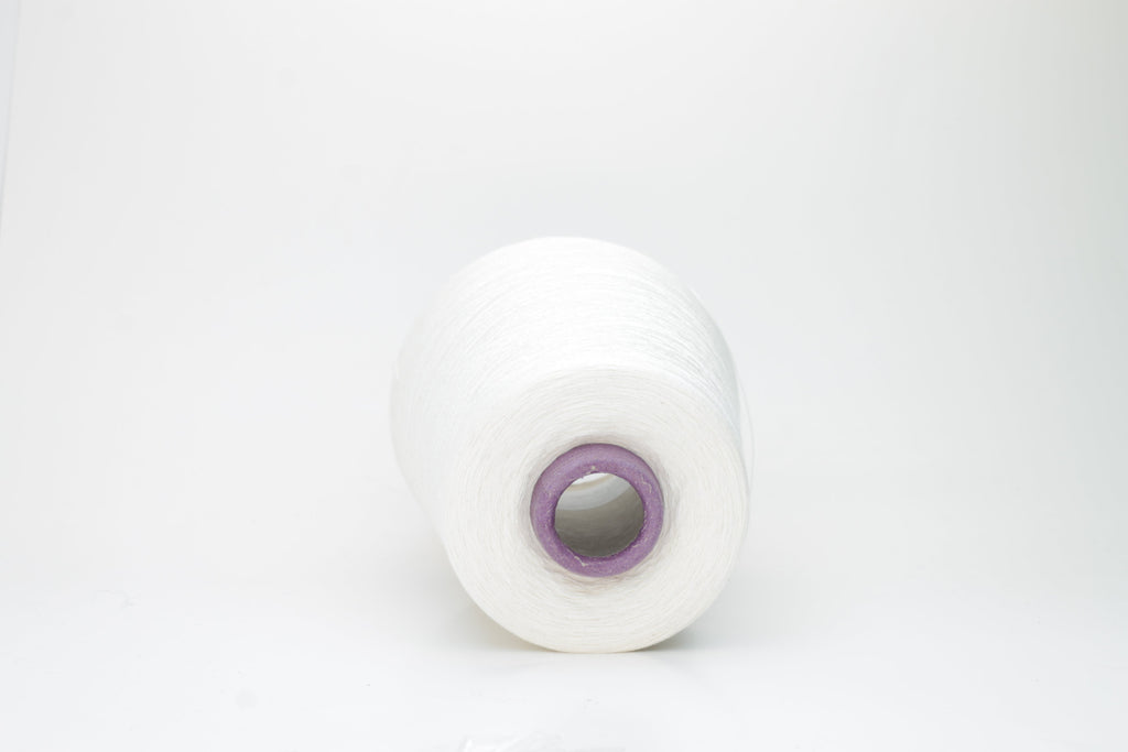 A meticulously spun, single-ply white yarn with a subtle sheen, gracefully coiled into a pristine hank, revealing its fine, smooth texture.