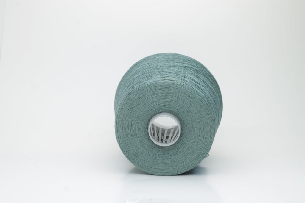 A finely spun skein of vibrant green silk cotton yarn with a subtle, natural sheen. The tight, smooth twist of the fibers is visible.