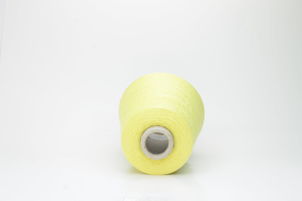 A finely spun, single-ply yarn in a vibrant, sunny golden-yellow. Smooth silk-cotton blend with a subtle, luxurious sheen and delicate twist.