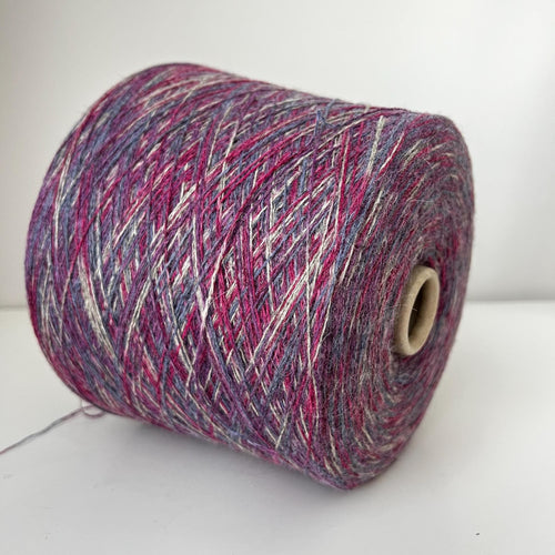 Close-up of soft, multi-ply blended yarn in variegated 'Stampa' shades, showcasing its delicate halo, subtle sheen, and gentle twist.