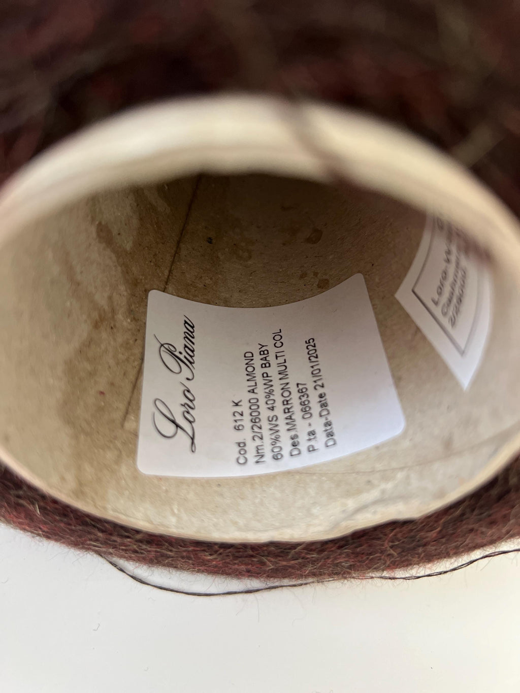 Soft, plush, deep marron brown yarn with a gentle, even twist, showcasing a subtle sheen and delicate halo. Neatly wound into a luxurious skein.
